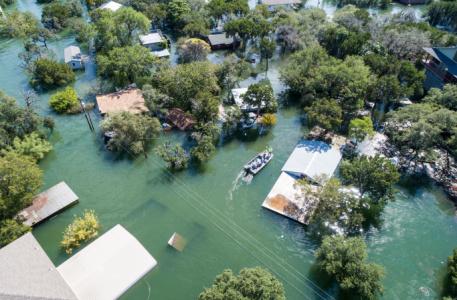 flooded houses with boat navigating between