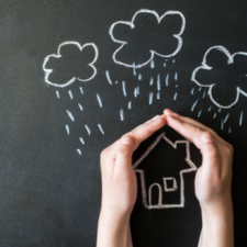 hands protects a house from the elements, rain or storm, homeowners insurance